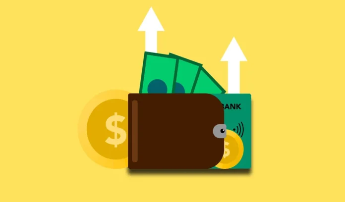 Main d'une personne tenant une carte de paiement au-dessus d'un ordinateur affichant des détails de transaction et un sy