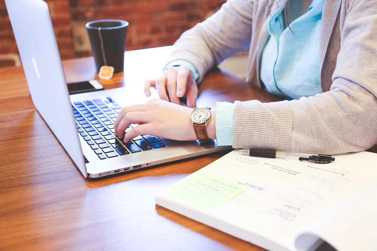 Étudiant en stage discutant avec un tuteur dans un bureau, préparation à l'insertion professionnelle