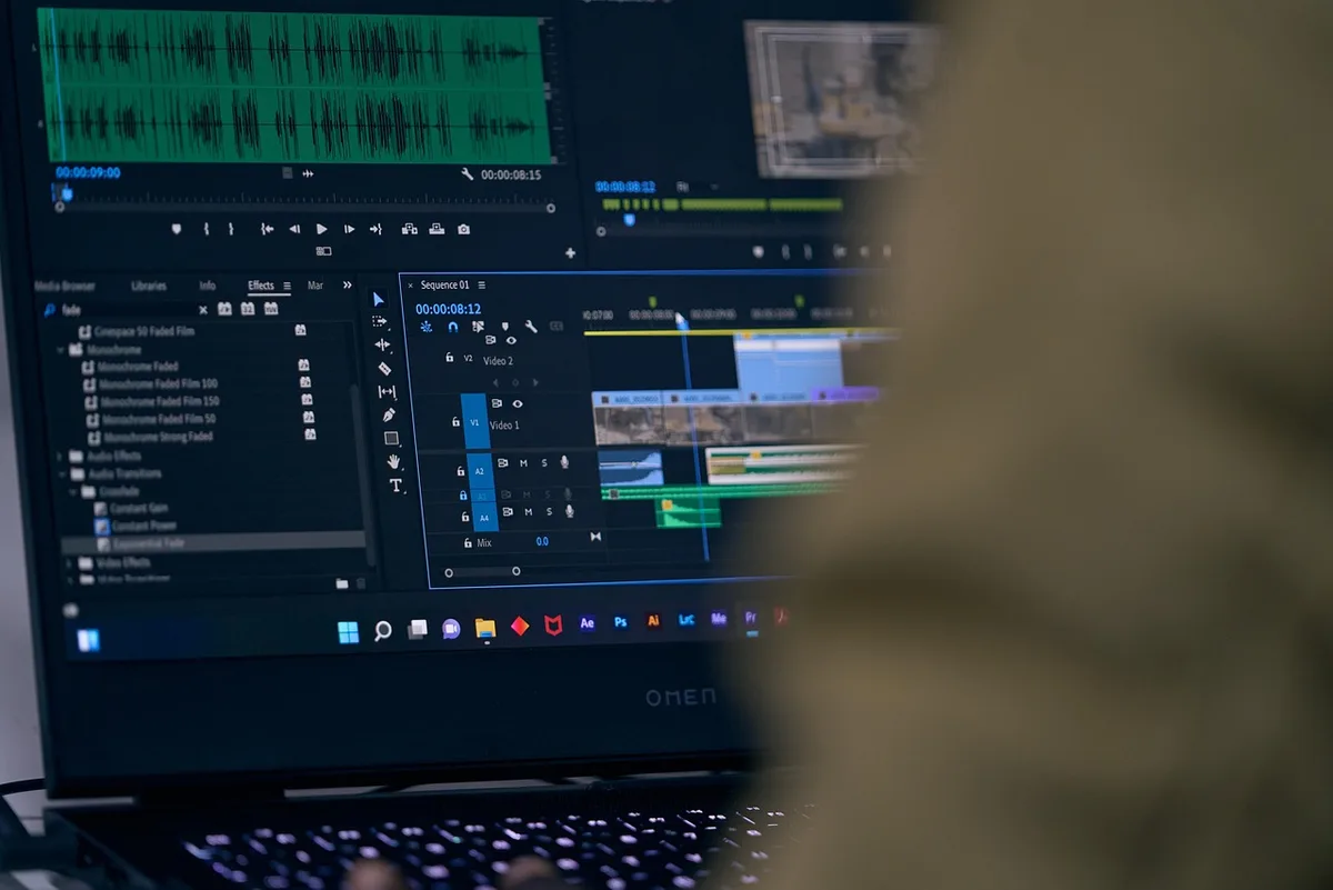 Poste de montage vidéo en lumière du jour avec écrans affichant séquences